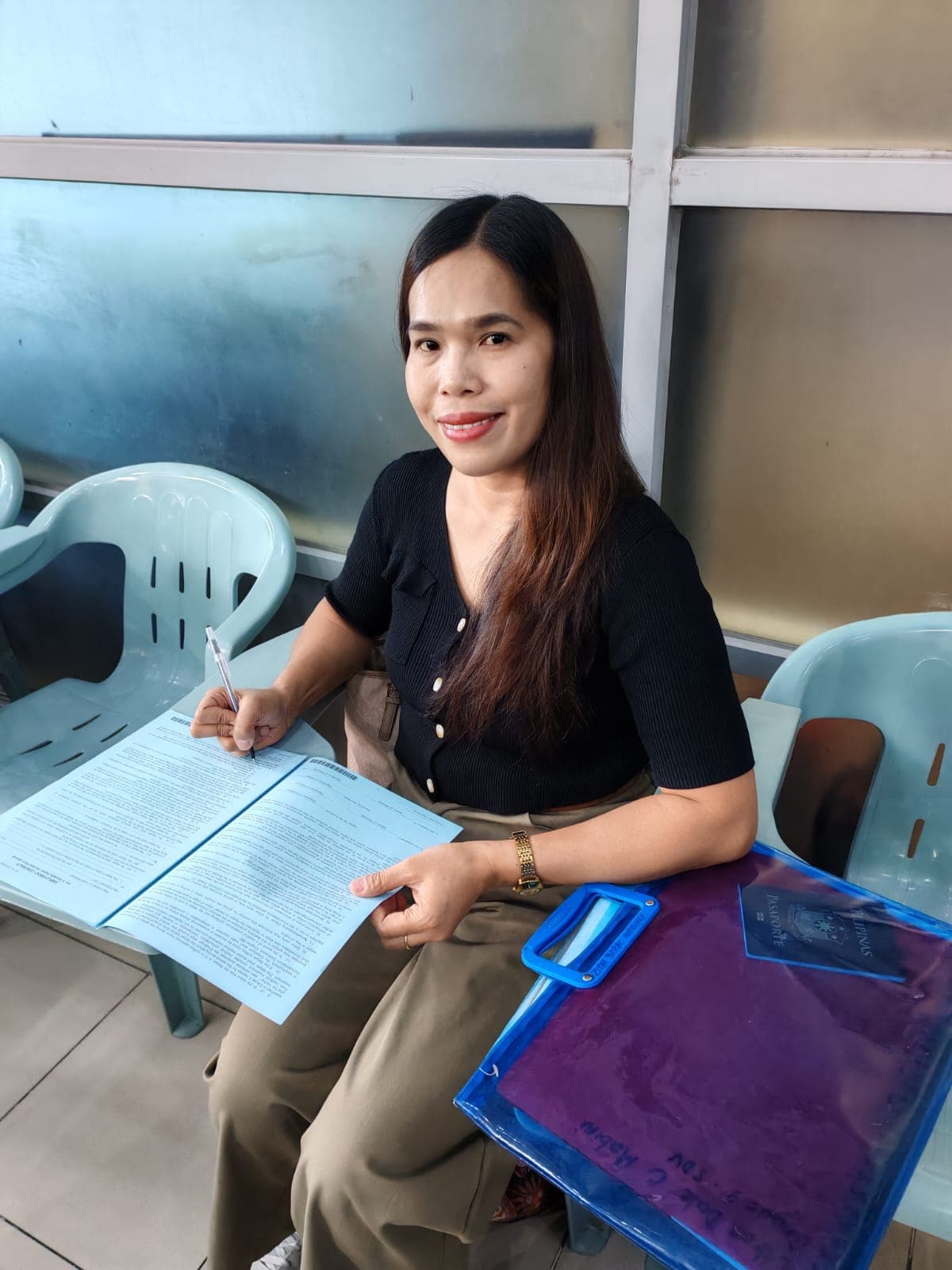 Helper signing employment contract